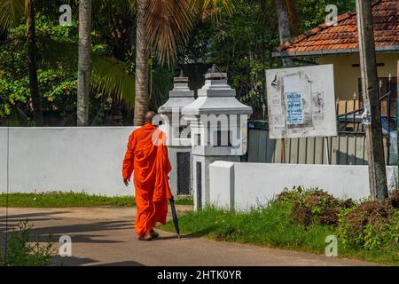 HIKKKADUWA, SRI LANKA - 6 DÉCEMBRE 2022 : un jeune moine descend la rue jusqu'au temple Banque D'Images