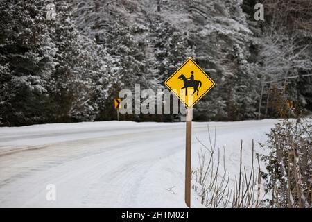Jaune attention Horse Riding Sign dans un cadre rural en hiver Banque D'Images
