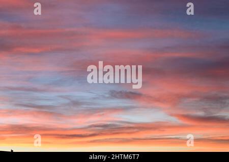 Un magnifique coucher de soleil mettant en valeur le rouge, les oranges, les violets et le bleu du soleil couchant Banque D'Images