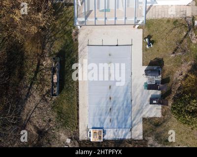 Un drone survolait une piscine couverte avec une bâche encore en construction dans un jardin Banque D'Images