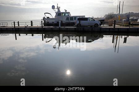 Wustrow, Allemagne. 02nd mars 2022. Le soleil se reflète dans l'eau du port de Bodden. Un temps exceptionnellement calme et ensoleillé domine la mer Baltique. Credit: Bernd Wüstneck/dpa-Zentralbild/dpa/Alay Live News Banque D'Images