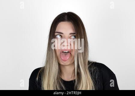 Jeune femme blonde sur un fond isolé expression dégoûtée, mécontente et craintive faisant le visage dégoût parce que réaction d'aversion. Ennuyeux. Banque D'Images