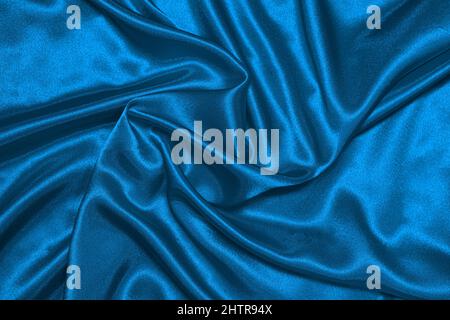 Texture de tissu bleu satiné froissé, magnifique motif, vue du dessus. Banque D'Images