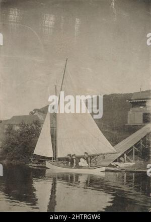 Photographie antique vers 1890, trois garçons sur un voilier à engin de forage en bref devant une maison de lac. Emplacement exact inconnu, probablement Nouvelle-Angleterre, Etats-Unis. SOURCE : PHOTO ORIGINALE Banque D'Images