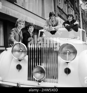 Les Bee Gees examinent un cadeau de Noël de l'agent Robert Stigwood, un 1948 Rolls Royce Silver Wraith, 12th décembre 1967. La voiture a été offerte comme cadeau spécial pour marquer et célébrer les 1 millions de ventes record de leur seul Massachusetts. Quatre des cinq membres du groupe regardent la voiture et lui donnent un vernis et propre. M. Stigwood a eu la voiture entièrement retapissée et peinte, et le moteur a été remis en état. Photo : Colin Peterson, Vince Melouney, Barry Gibb et Robin Gibb dans Adams Row, Mayfair (Robin Gibb n'était pas disponible pour la photo) Banque D'Images