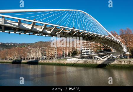 The Zubizuri (Basque for 'white bridge') is a tied arch footbridge which spans across the Nervion River in Bilbao, Spain Stock Photo