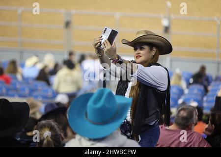 Houston, États-Unis. 4th mars 2022. Une femme prend un selfie lors du Houston Livestock Show à Houston, Texas, États-Unis, le 4 mars 2022. Le Houston Livestock Show and Rodeo, avec une histoire de 90 ans, est plein de culture de cow-boy et les coutumes de l'Ouest américain. Le festival débute le 28 février de cette année et se termine le 20 mars. Credit: Xu Jianmei/Xinhua/Alamy Live News Banque D'Images