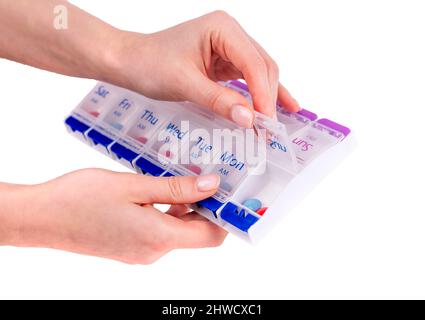 Femme mains ouvrant boîte de pilules isolé sur fond blanc. Utilisation de comprimés et de vitamines pour le traitement et la guérison de maladies. Photo de haute qualité Banque D'Images