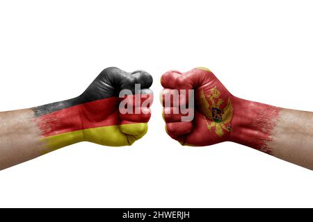 Deux mains poinçonner l'une à l'autre sur fond blanc. Drapeaux de pays peint les poings, le concept de crise de conflit entre l'allemagne et le monténégro Banque D'Images