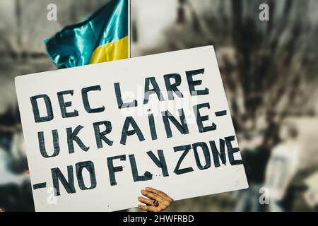 Signe à Ukrainian support Rally lit déclarer Ukraine No Fly zone - contre l'extérieur flou d'arrière-plan avec l'Ukraine drapeau Banque D'Images