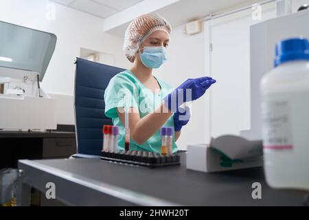 Assistant de laboratoire vérifiant les informations dans l'hôpital Banque D'Images