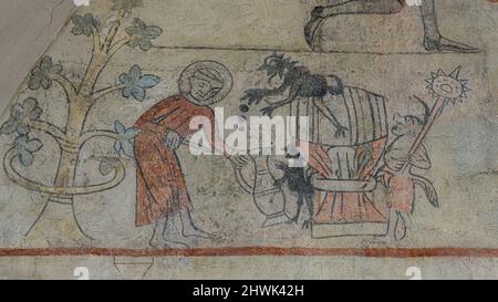 monk versant de la bière à partir d'un baril, fresque ancienne sur le mur est de l'église Orslev, Danemark, 9 août 2021 Banque D'Images