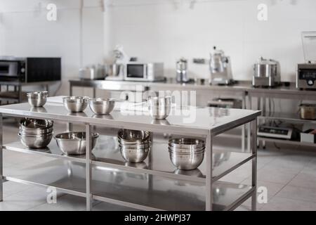Cuisine de restaurant professionnelle avec équipement de cuisine et tables en acier inoxydable. Intérieur sans personne Banque D'Images