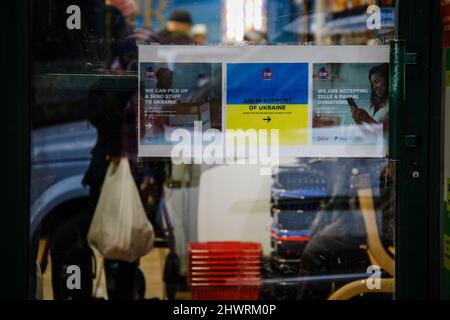 Résidents et boutiques de Brighton Beach. Beaucoup portent les couleurs jaune et bleu du drapeau ukrainien pour montrer leur soutien. Le magasin « Taste of Russia » a retiré son panneau, qui sera bientôt renommé. Les plus grandes communautés ukraniennes-américaines de New York sont situées dans les zones de Brighton Beach et Sheepshead Bay à Brooklyn. Brighton Beach a été surnommé Little Odessa en raison de sa population d'immigrants d'Ukraine, de Russie et d'autres territoires ex-soviétiques. Pris le 5 mars 2022, à Brooklyn, New York . Partout dans le monde, des gens ont affiché des panneaux et suspendu des drapeaux ukrainiens pour soutenir l'Ukraine Banque D'Images