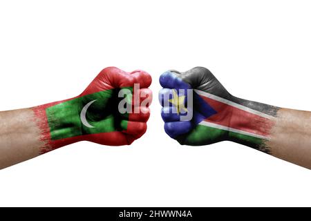 Deux mains poinçonner l'une à l'autre sur fond blanc. Drapeaux de pays peints Fists, conflit concept de crise entre les maldives et le sud du soudan Banque D'Images