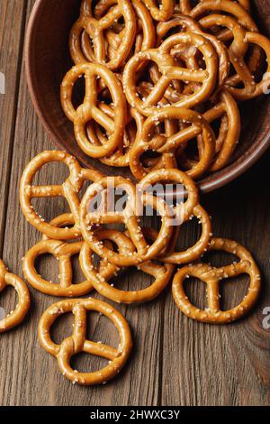 Bretzels dans un bol en céramique sur fond de bois gros plan. Bretzels Flat Lay, vue de dessus Banque D'Images