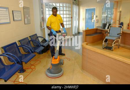 Un employé de Rentokill initial Hospital Services qui a poli l'étage de la salle d'attente.(MODÈLE RELÂCHÉ) Banque D'Images