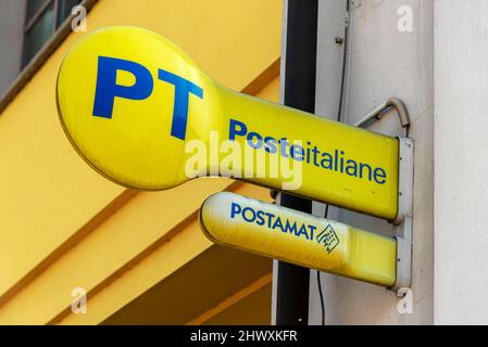 Fossano, Cuneo, Italie - 07 mars 2022: PT Italie logo de poste et signe postamat sur le panneau jaune à l'extérieur du bureau de poste italien Banque D'Images