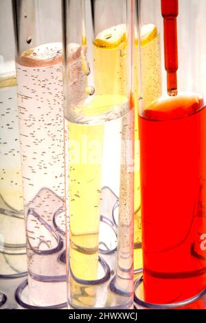 Pipetage de liquide rouge dans des tubes à essai (Medicamage) Banque D'Images