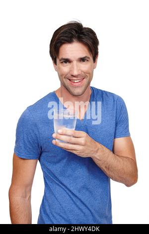 C'est rafraîchissant. Studio portrait d'un beau jeune homme tenant un verre d'eau. Banque D'Images