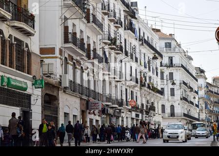 Foule de personnes marchant dans la rue Didouche Mourad dans le centre-ville d'Alger. Les voitures sont dans l'embouteillage. Banque D'Images