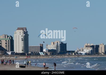 En hiver, deux parapentes survolent la plage de South Padre Island, Texas. Sur un parapente motorisé, le pilote porte un moteur de sac à dos. Banque D'Images