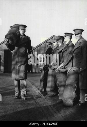 Grand - mais ils doivent le croire -- Harry Lectures, les plus hauts d'entre eux tous, passe d'autres recrues à la parade de Kitting-out au jour le jour. La ligne d'approvisionnement de l'Armée de terre a été longtemps tracée au jour le jour (mercredi), lorsque la recrue Harry Lectures, âgée de 18 ans, a assisté à une parade de départ au dépôt des gardes, à Caterham, Surrey. Pour Harry, ancien monteur de gaz de Brookside, Ascot, Berkshire, est 6ft. de hauteur de 8 pouces, pèse plus de 14 pierres et prend la taille 13 dans les pieds. Autre problème pour les pourvoyeurs militaires - Harry est toujours en croissance. 1 décembre 1954. (Photo de Reuterphoto). Banque D'Images