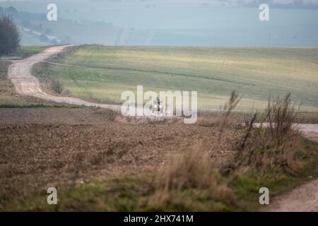 un quad avec des lumières sur la conduite de son quad hors-route le long d'une piste de pierre campagne ouverte Banque D'Images