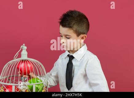 garçon de 4 ans représenté avec des gestes en studio avec un arrière-plan couleur. Banque D'Images