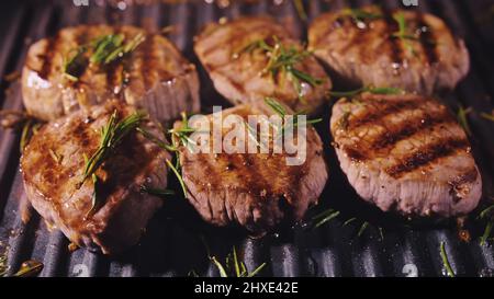 Délicieux steak de viande juteux cuisant sur le gril. Filet de rôtis de qualité ancien et rare dans du bœuf tendre en marbre frais. Frites de bœuf de choix sur un rôti électrique Banque D'Images