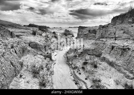 Paysage contrasté en niveaux de gris profond dans la crique basse sèche après les cours d'eau à Walls of china paysage érodé pittoresque du lac Mungo, Australie. Banque D'Images