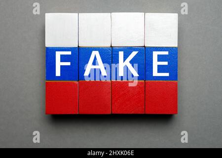 Mensonge médias Russie news design poster. Caractères d'imprimerie isolés mot de bois faux dans le drapeau russe couleurs cubes. Cubes en bois avec texte concept fausses nouvelles Banque D'Images