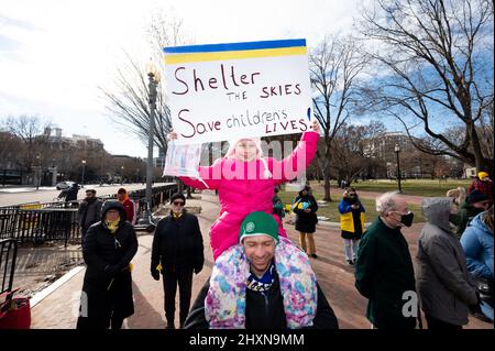 Washington, États-Unis. 13th mars 2022. Une jeune fille porte un panneau indiquant « Shelter the SKIES Save Children Lives ! » Lors d'un rassemblement en face de la Maison Blanche pour soutenir l'Ukraine. Crédit : SOPA Images Limited/Alamy Live News Banque D'Images