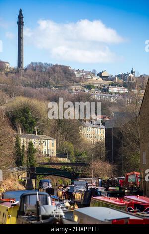 Sowerby Bridge, West Yorkshire, Royaume-Uni. 14th mars 2022. Météo au Royaume-Uni. Un beau ciel bleu et une journée ensoleillée au bassin historique du pont Sowerby, sur le canal Calder & Hebble/Rochdale, qui offre des amarres et des services de chantier agréables et sécurisés à l'ombre de la tour Wainhouse classée en Grade2. Le port de plaisance a été utilisé comme un emplacement pour divers dramatiques de télévision, y compris le thriller Sarah Lancashire "Happy Valley". Crédit : Windmill Images/Alamy Live News Banque D'Images