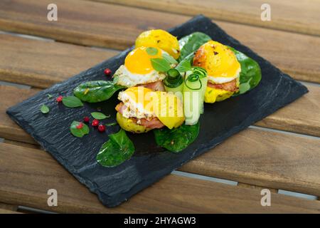 Gros plan des mini burgers des œufs de caille avec des pommes de terre cuites à l'assiette avec des légumes verts Banque D'Images