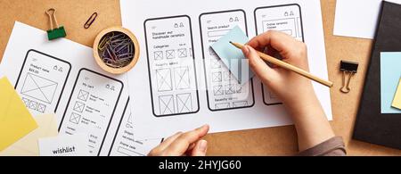 Concept de projet de site Web réactif. Concepteur Web UX travaillant au bureau avec de nombreuses esquisses d'éléments filaires d'app. Style de bannière. Banque D'Images
