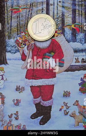 carte de noël du père noël avec une pièce d'un euro sur son visage Banque D'Images