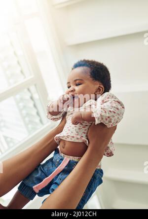 Shes assez ludique. Photo d'une mère tenant sa petite fille souriante. Banque D'Images