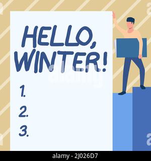 Affiche textuelle indiquant Hello Winter. Approche d'affaires saison la plus froide de l'année dans les zones polaires et tempérées Homme debout portant un grand ordinateur portable pendant Banque D'Images