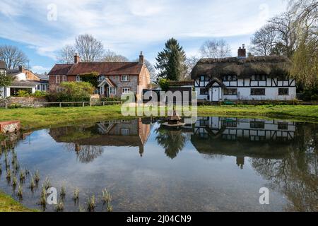 Village d'Oakley avec étang à canards et chalets dans le Hampshire, Angleterre, Royaume-Uni Banque D'Images