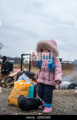 Photo verticale d'une fille ukrainienne debout avec des bagages dans un camp de Medyka, en Pologne Banque D'Images