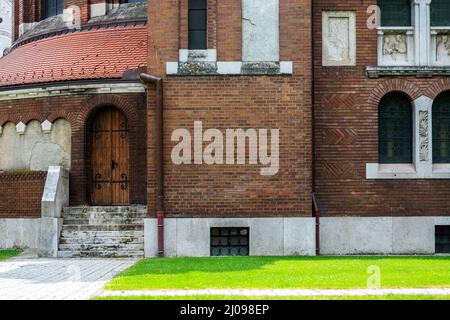 Fragment de la cathédrale dans la ville de Szeged en Hongrie avec une porte et des marches en pierre. Banque D'Images