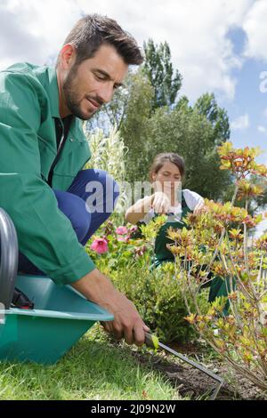 Homme de flou artistique le ratissage des feuilles au jardin Banque D'Images