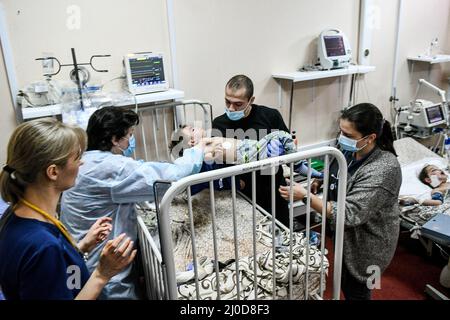 Zaporizhzhia, Ukraine. 18th mars 2022. Un medic met un petit garçon sur le lit à l'hôpital clinique régional pour enfants de Zaporizhzhia où les enfants qui ont subi de graves blessures lors des bombardements des troupes russes sont traités, Zaporizhzhia, dans le sud-est de l'Ukraine. 18 mars 2022. Photo de Dmytro Smolyenko/Ukrinfrom/ABACAPRESS. Credit: Abaca Press/Alay Live News Banque D'Images