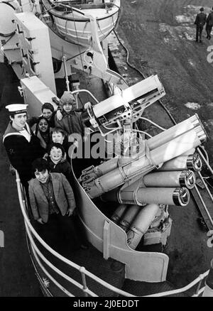 Des écoliers qui visitaient le HMS Jupiter se sont amarrés sur les quais de son port d'attache adopté, Middlesbrough. Phil Eales, électricien de contrôle, est photographié pour expliquer à un groupe d'enfants de l'école junior de la route d'Abingdon certains de l'armement de Jupiter. 18th janvier 1978. Banque D'Images