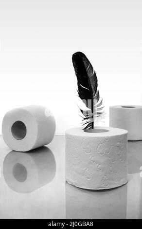 Papier toilette et plume d'oiseau, symbole du toucher doux. Banque D'Images