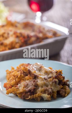 Pâtes au gratin avec salade sur bois Banque D'Images