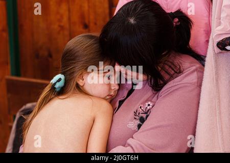 Uzhhorod, Ukraine. 19th mars 2022. Une femme berce une fille dans un gymnase d'un établissement scolaire où près de 300 personnes déplacées à l'intérieur de leur propre pays qui ont fui l'invasion russe séjourneront, à Uzhhorod, dans la région de Zakarpattia, dans l'ouest de l'Ukraine, le 18 mars, 2022. Photo de Serhii Hudak/Ukrinform/ABACAPRESS. Credit: Abaca Press/Alay Live News Banque D'Images