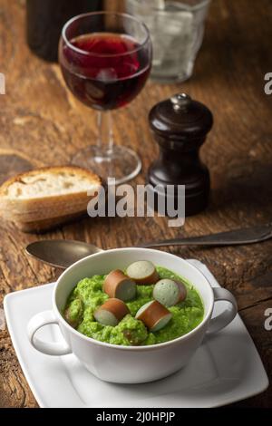 Soupe crémeuse aux pois sur bois sombre Banque D'Images