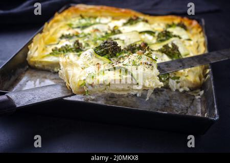 Tarte française traditionnelle avec courgettes et bébé brocoli servi sous forme de gros plan Banque D'Images